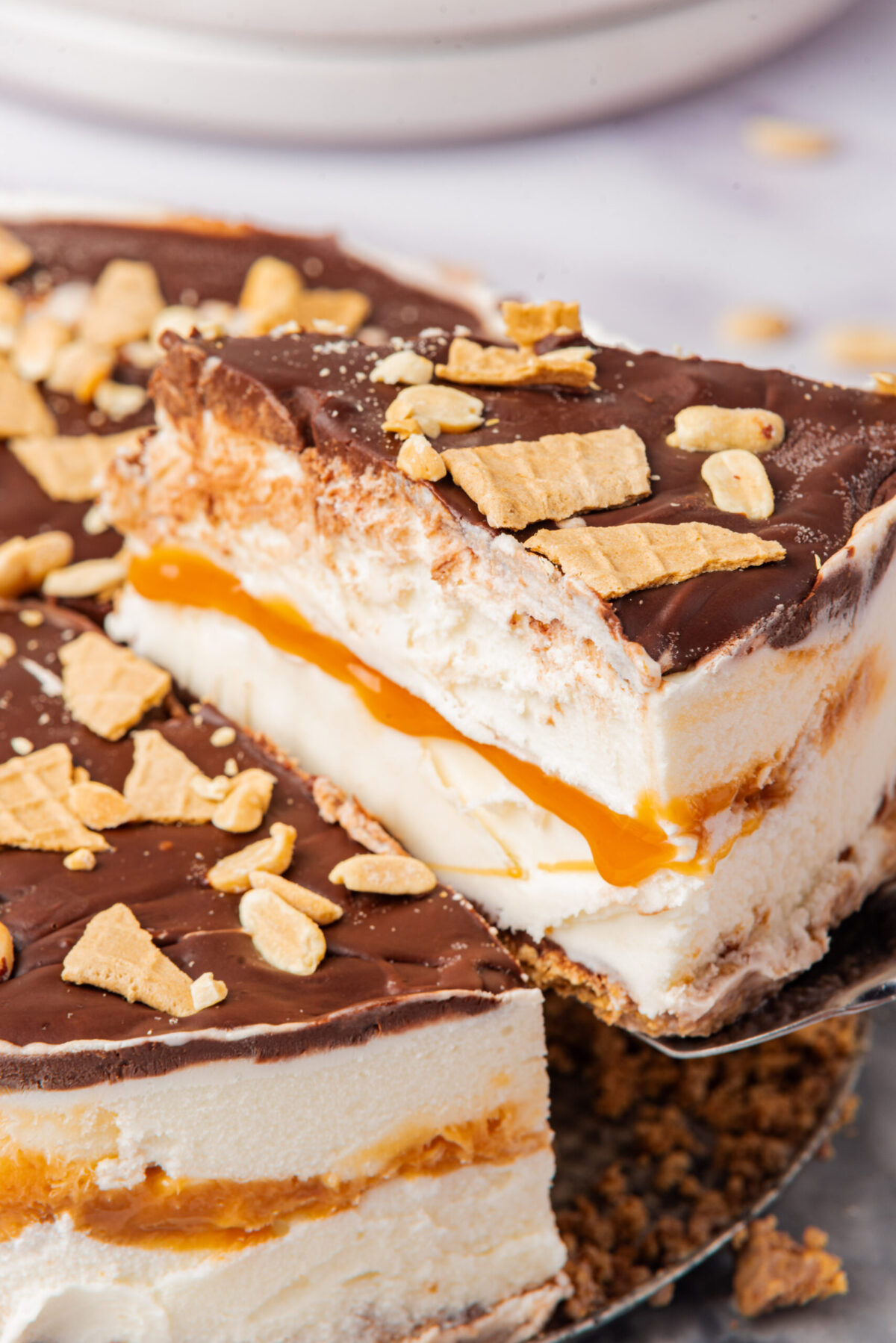Drumstick pie with vanilla ice cream, caramel, chocolate, and crushed waffle cone pieces.
