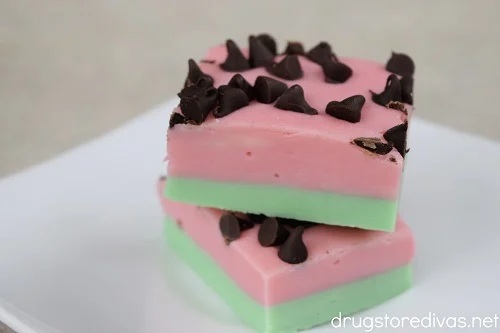 Two-tone watermelon fudge with a green bottom, pink top, and chocolate chips on top resembling seeds.