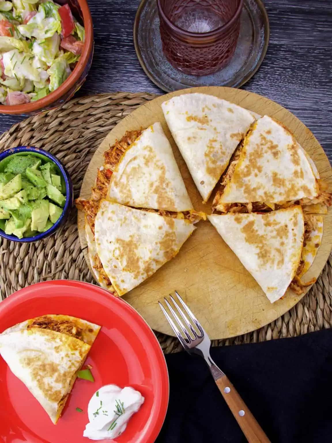 Quesadillas with shredded chicken and cheese, served with sour cream.