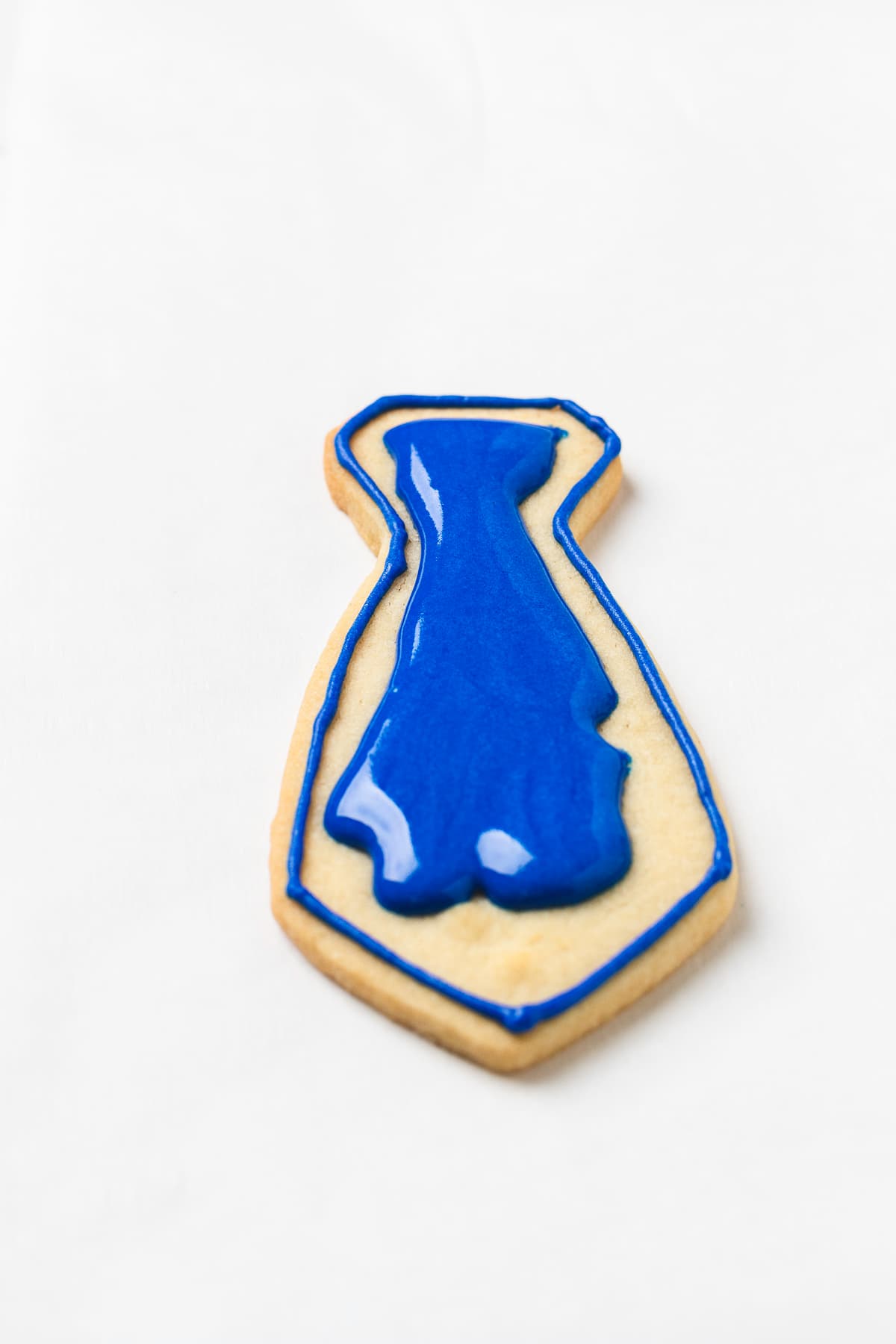 Necktie cookie flooded with royal icing.