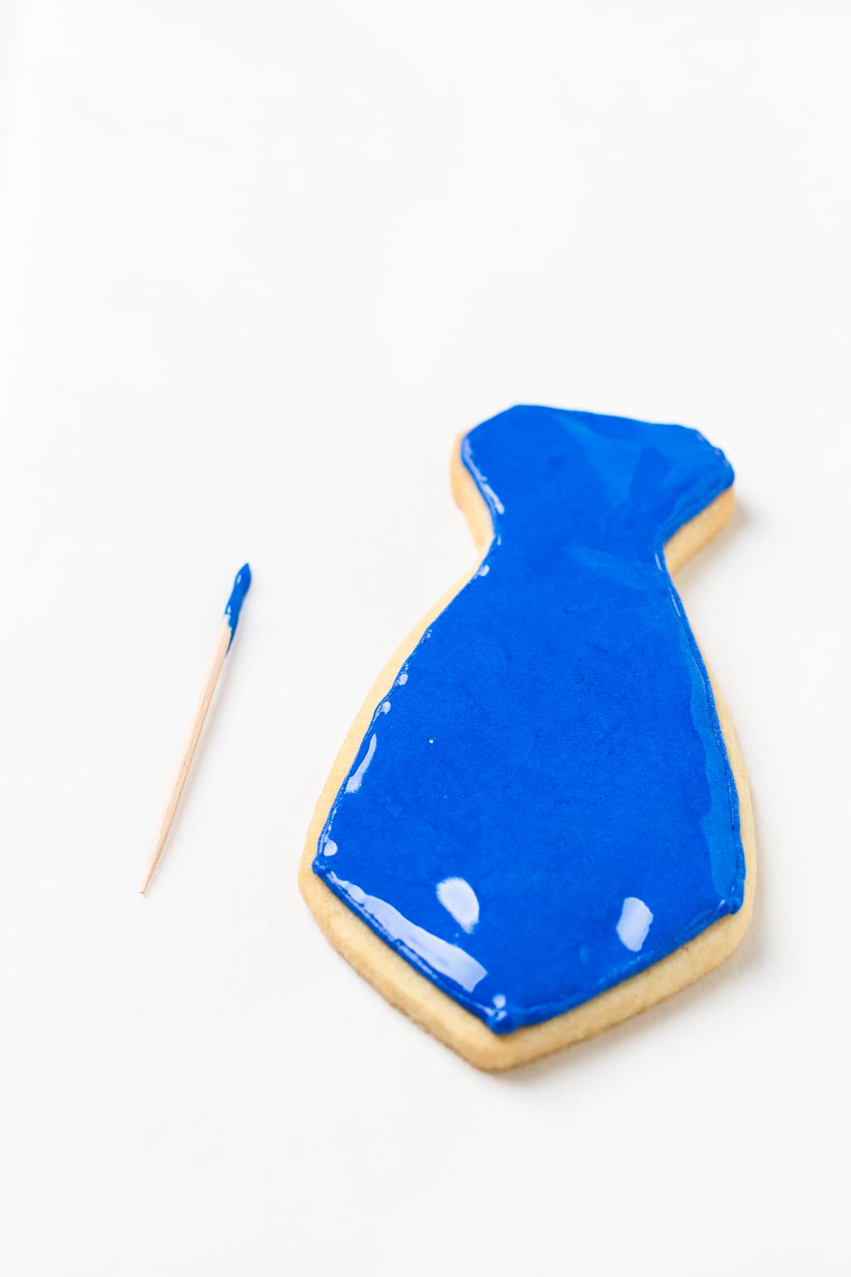 Completely smoothed out royal icing on necktie cookie.