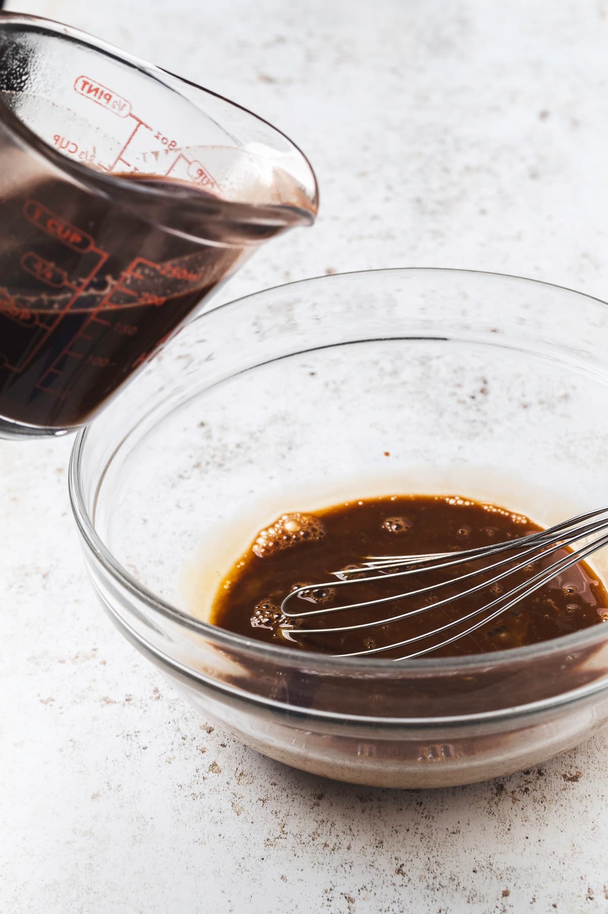 Combining chocolate-sugar mixture with egg yolks continued.