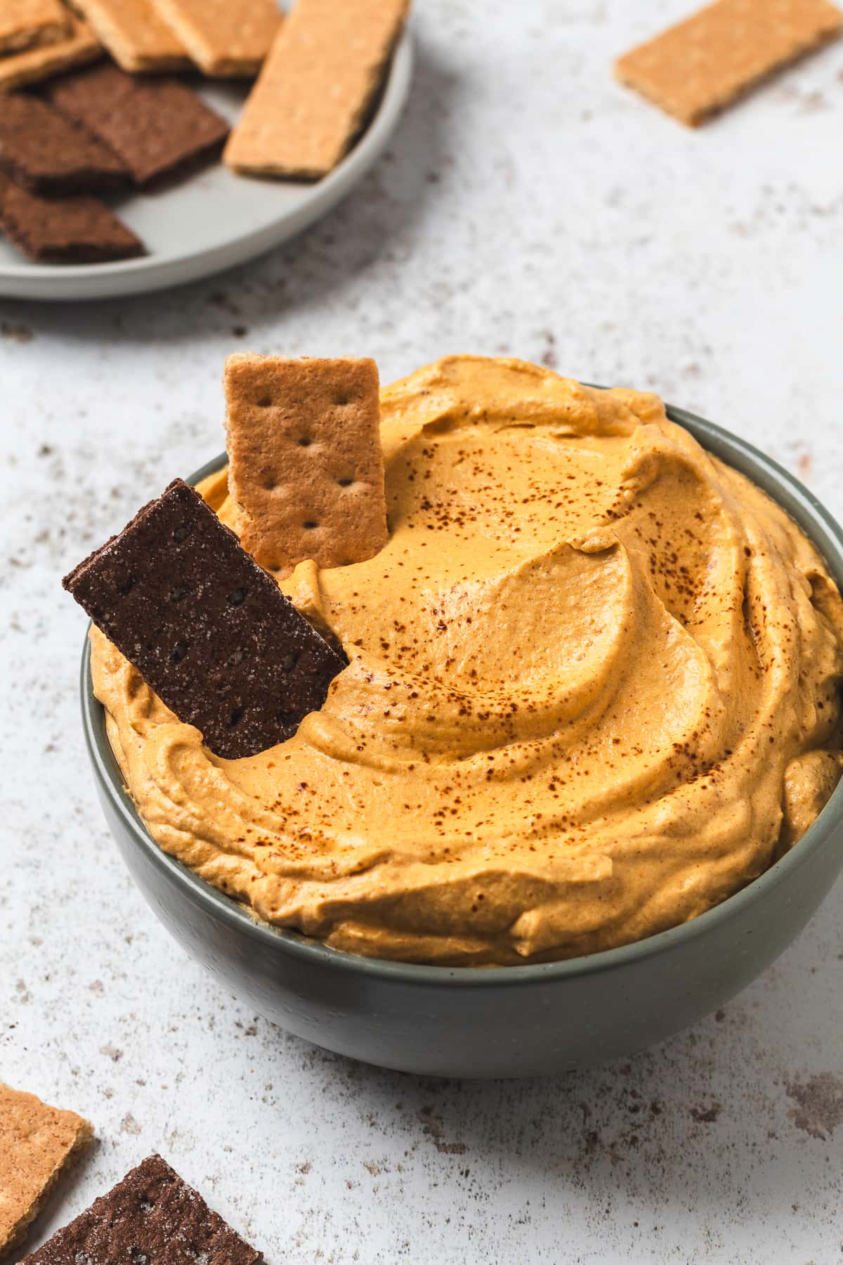 Pumpkin spice latte dip in a bowl with graham crackers.