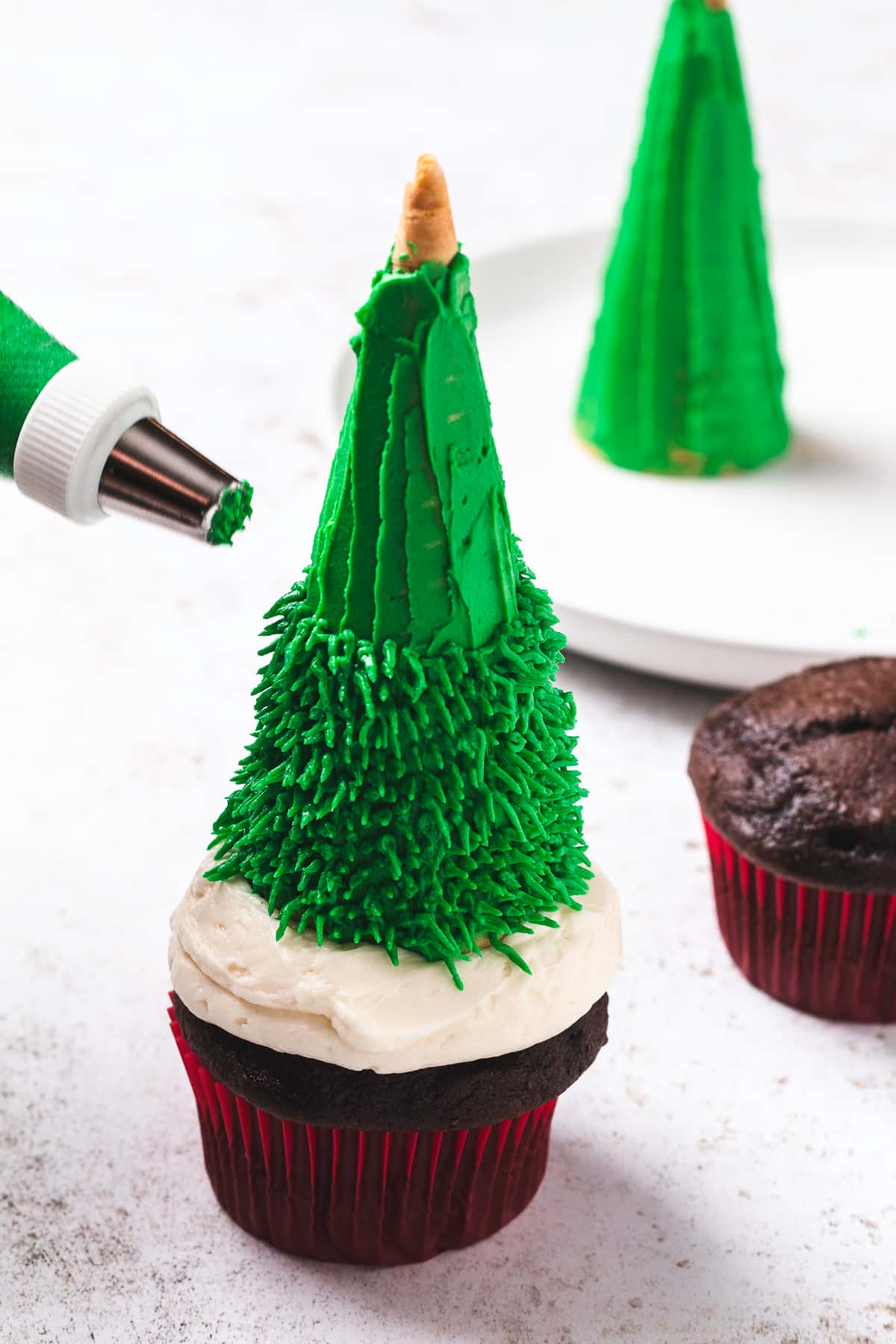 Adding texture to Christmas tree cupcakes.