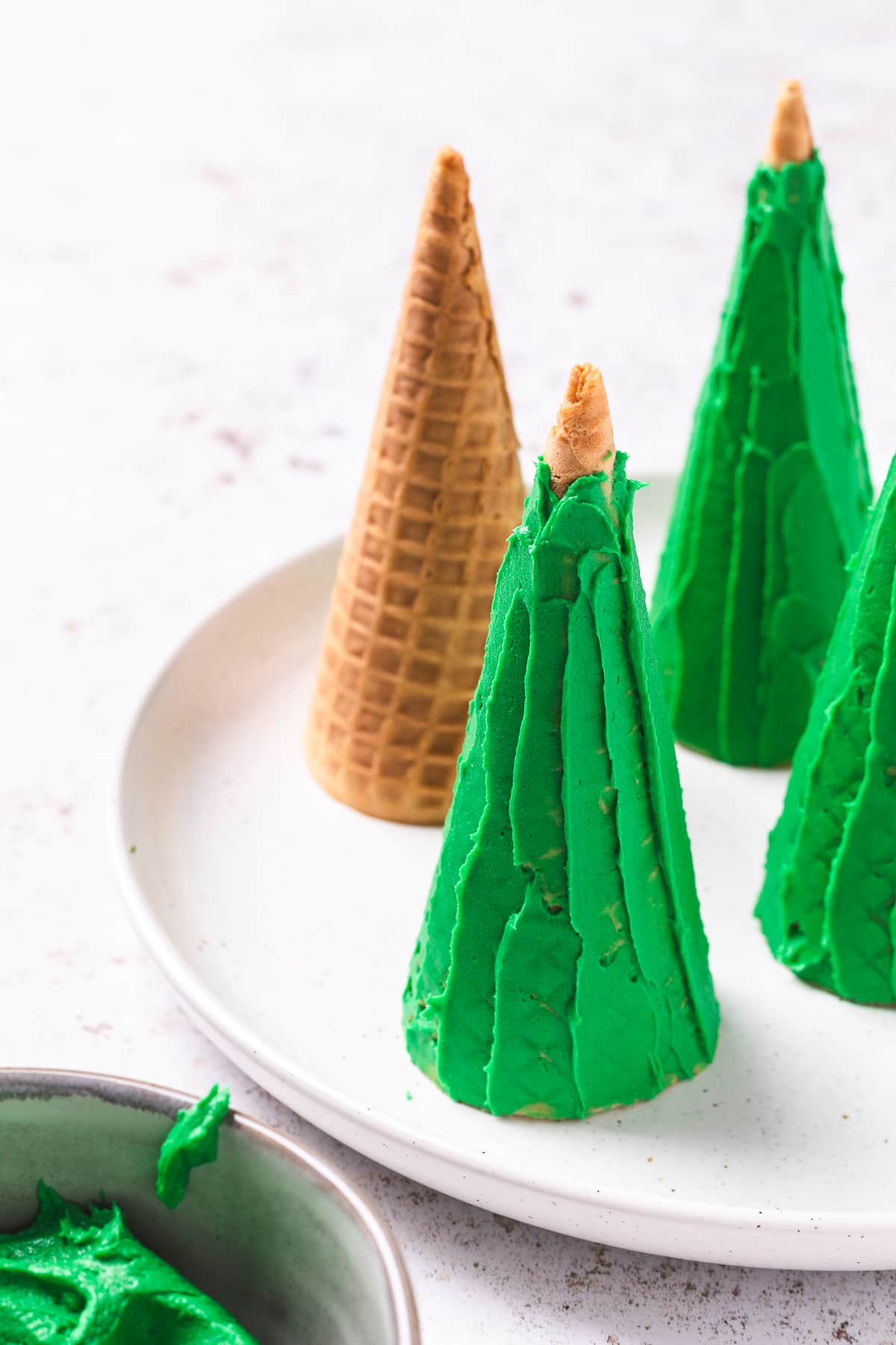 Green frosted sugar cones of light colored plate.