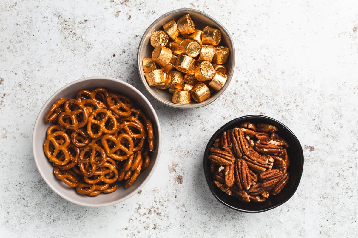 Ingredient shot showing pretzels, Rolos candy, and pecan halves.