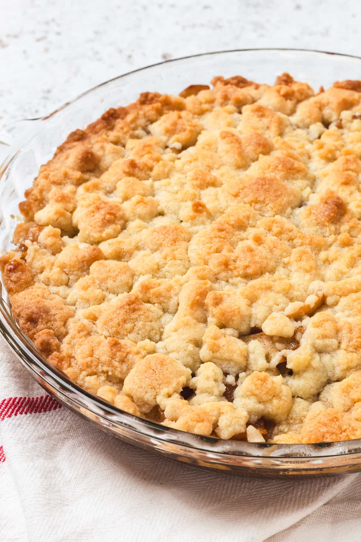 Golden brown caramel apple cobbler fresh from the oven, with a crisp, buttery topping.