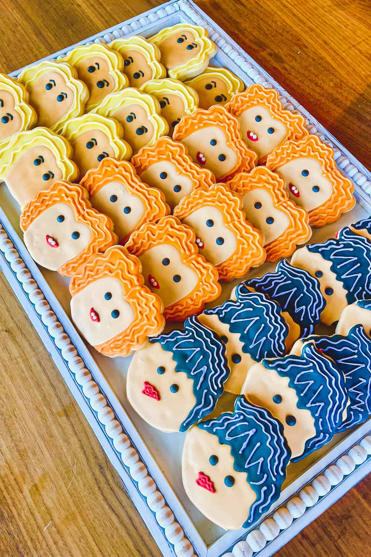 Hocus Pocus sugar cookies decorated to look like the Sanderson sisters with colorful icing.