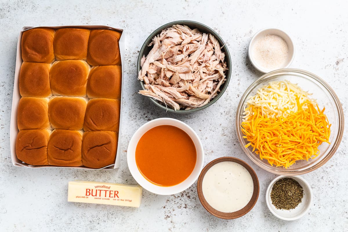 Ingredients for buffalo chicken sliders arranged on a table before assembly.