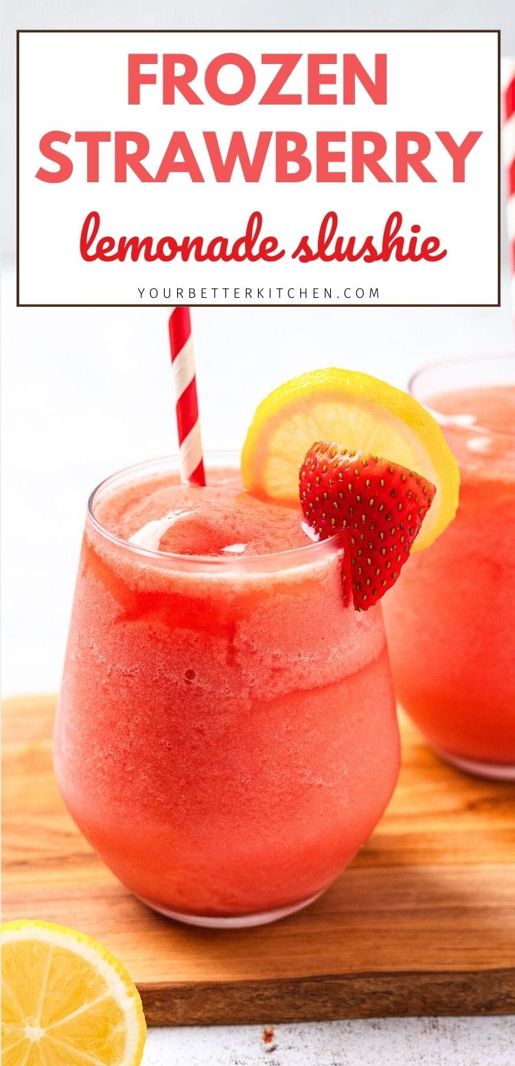 A white cup of pink frozen strawberry lemonade slushie sits on a table with a striped straw.