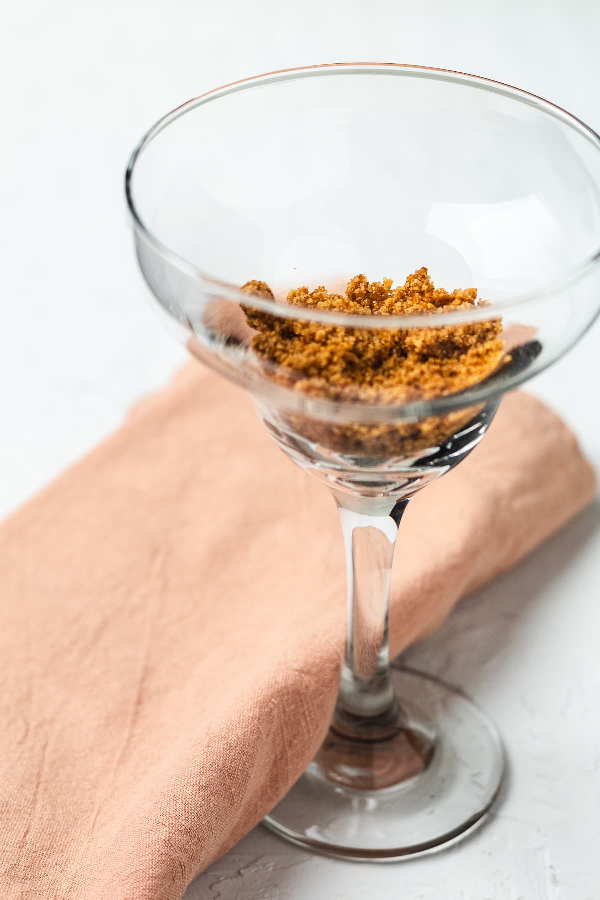 Martini glass with graham cracker crumbs, pin shows frozen key limeade dessert drink recipe.