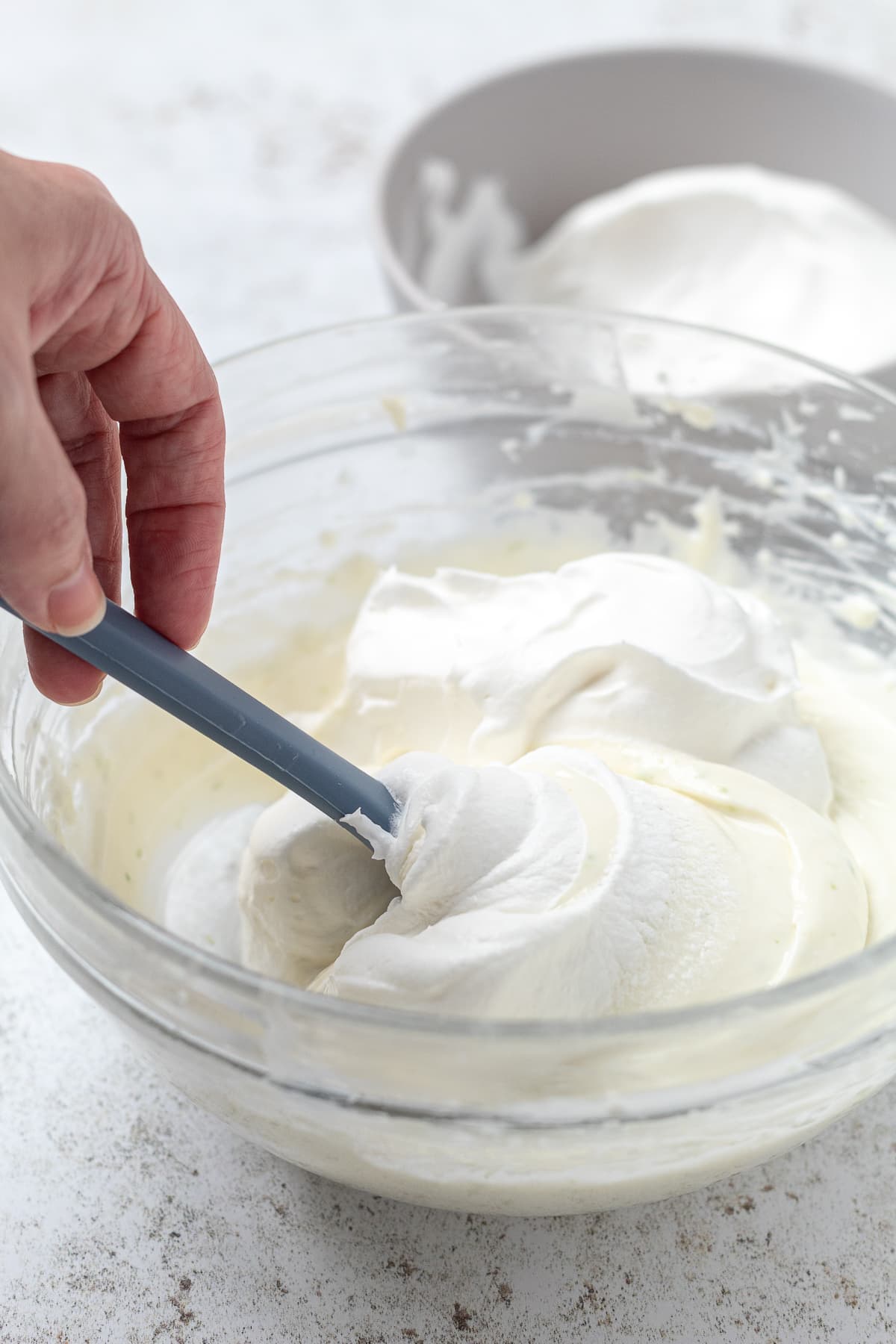 Whipped topping being folded into creamy margarita dip mixture.