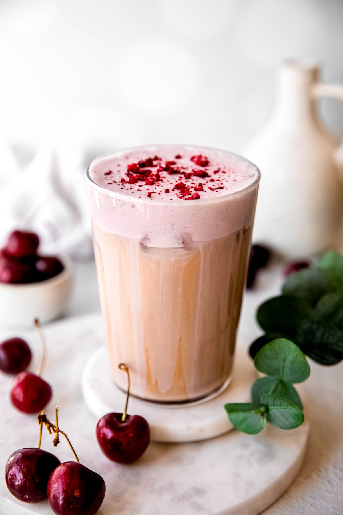 Creamy iced cherry chai latte topped with frothy foam.