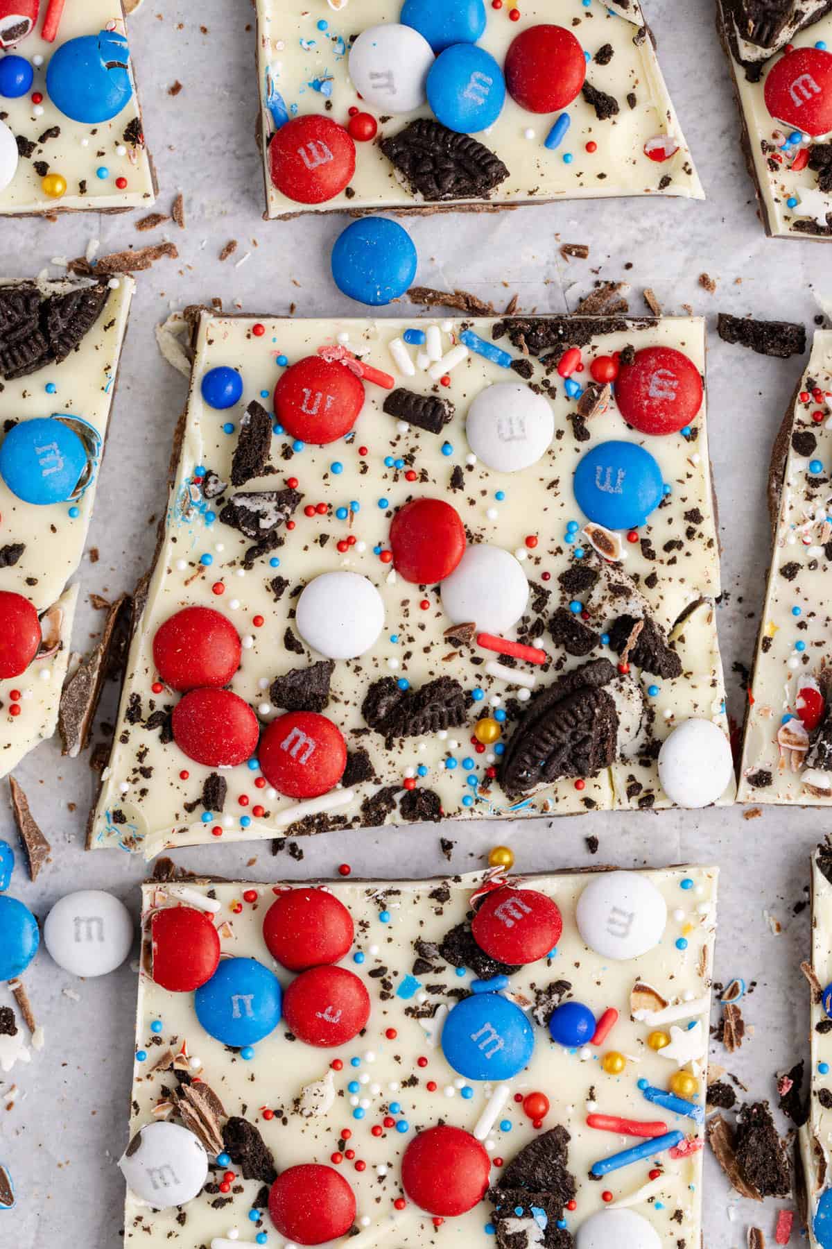 Red, white, and blue candy bark with chocolate, cookies, and sprinkles.