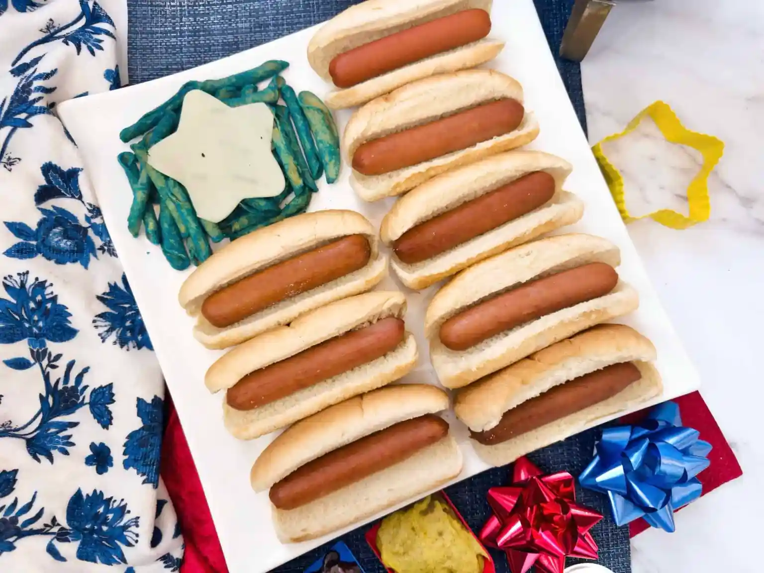 American flag hot dog platter with mini hot dogs on buns and blue star chips.