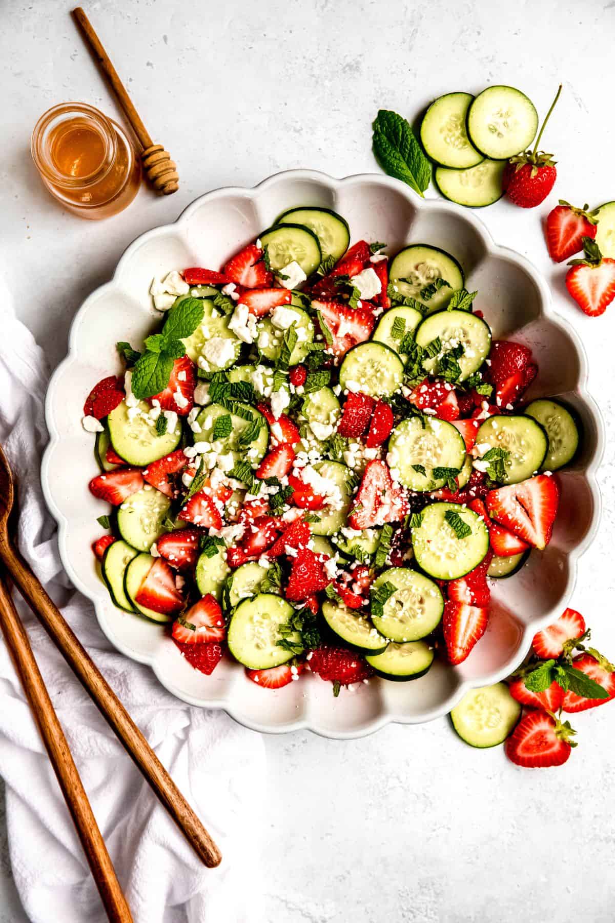 Strawberry cucumber salad with feta, fresh herbs, and sliced strawberries.