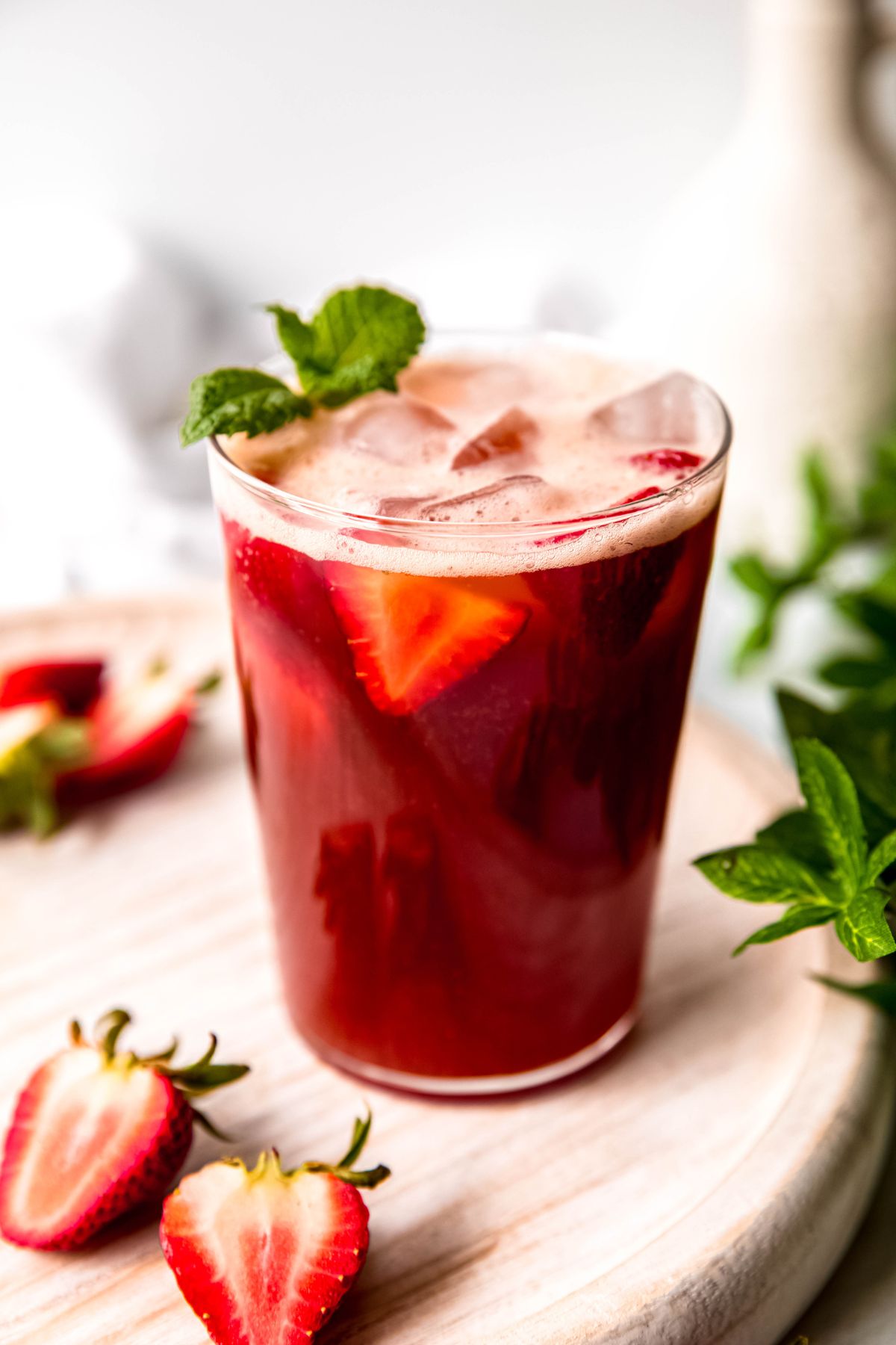 Strawberry iced tea with fresh strawberries and mint.