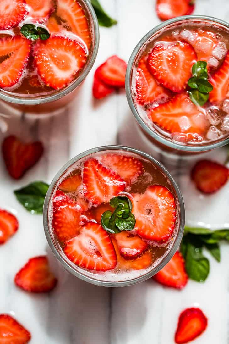 Strawberry kombucha mocktail with fresh fruit slices.