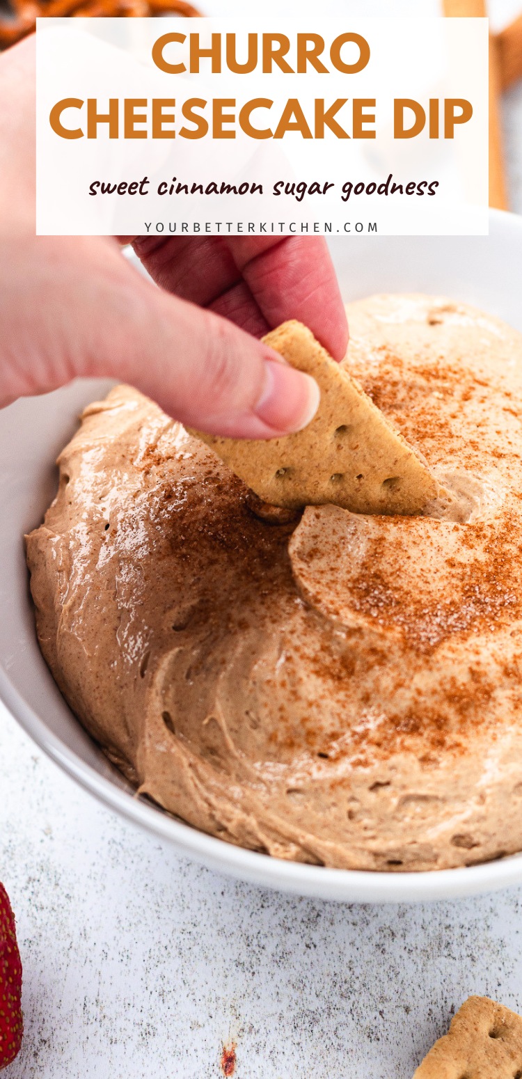 Bowl of churro cheesecake dip with a strawberry being dipped with text the reads Churro Cheesecake Dip sweet cinnamon sugar goodness.