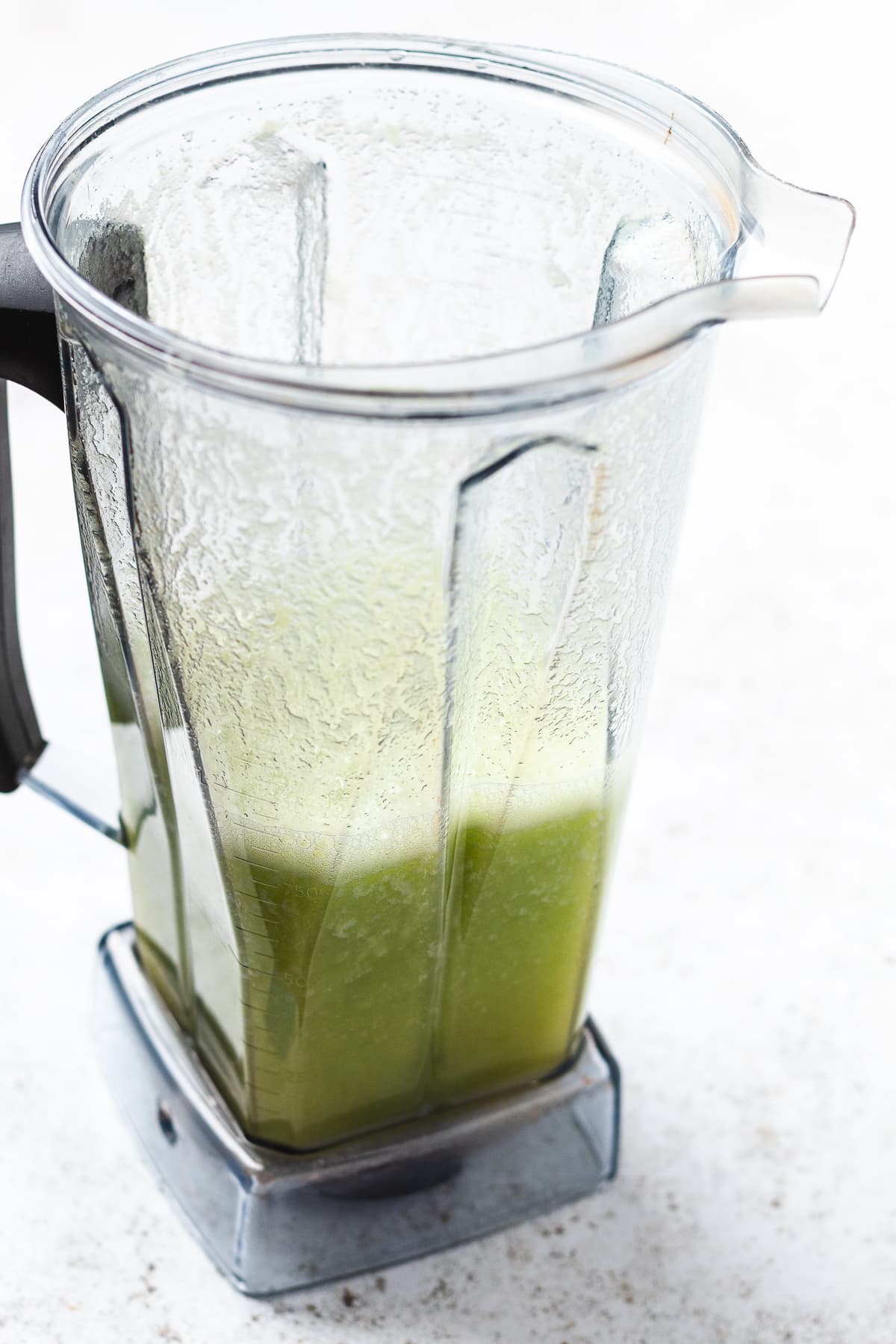 Blended cucumber mixture in blender for agua fresca recipe.