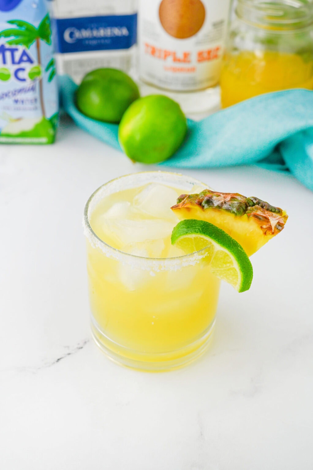 Hawaiian margarita with pineapple garnish and salted rim.