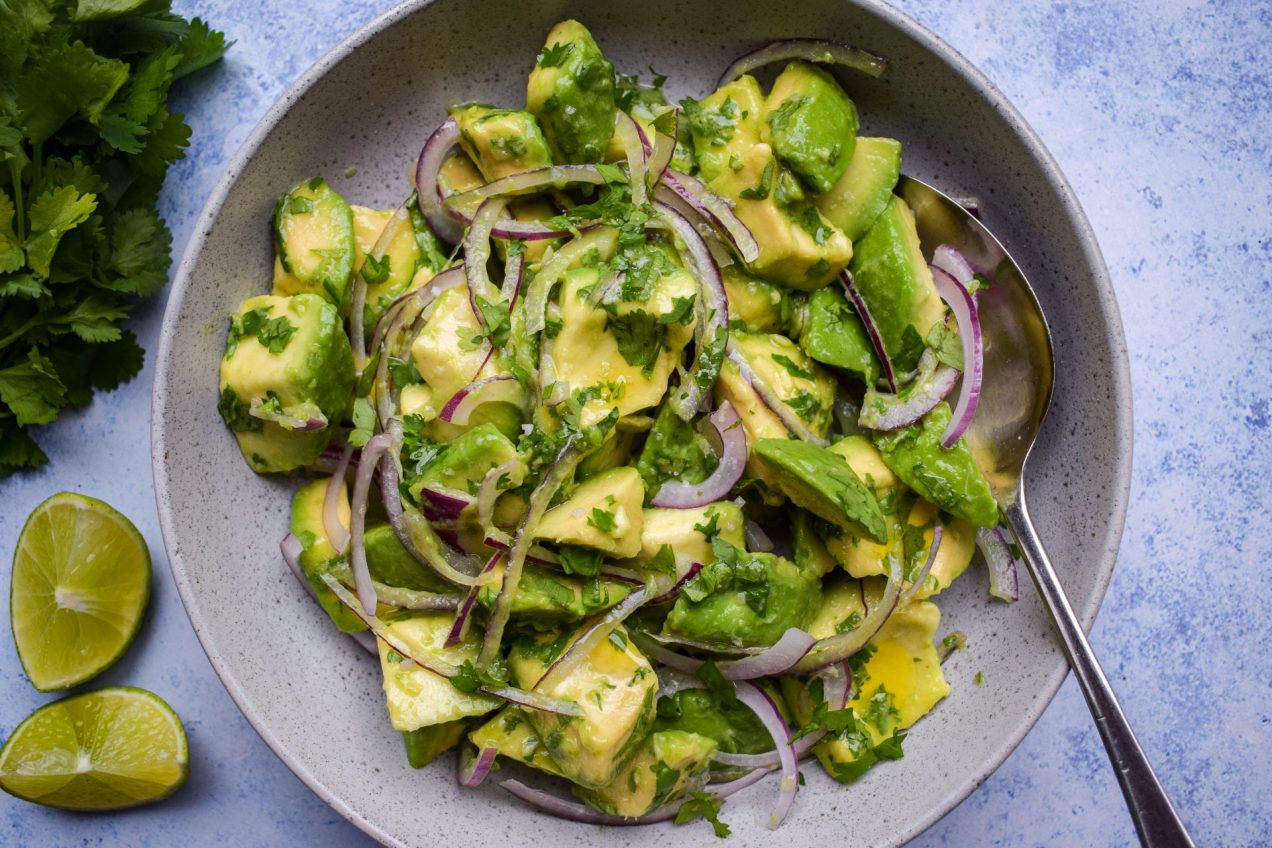 Avocado salad with red onion, cilantro, and lime dressing.
