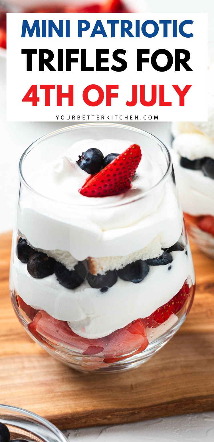 Mini patriotic trifles with strawberries, blueberries, cake, and whipped cream in a glass.
