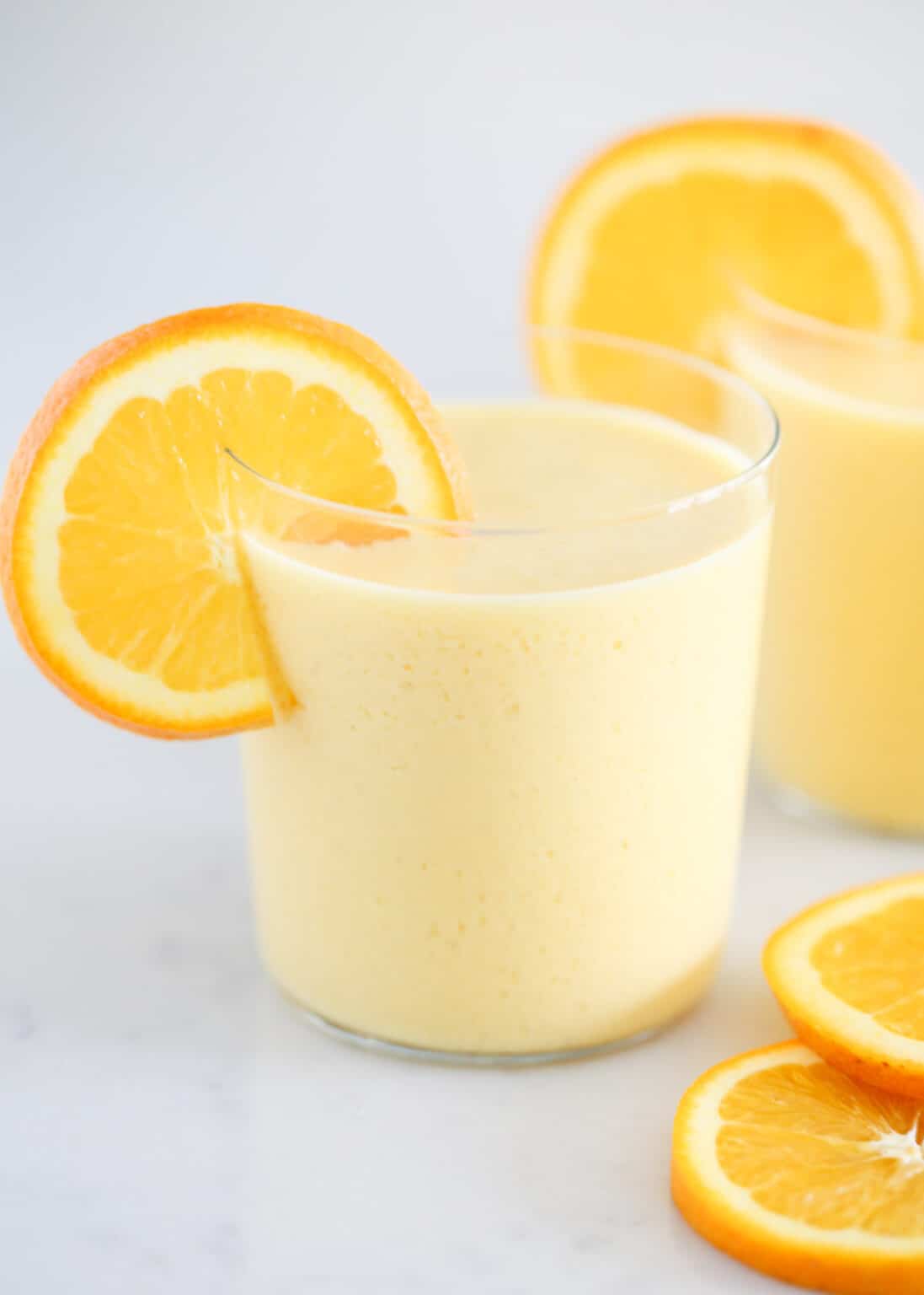 Orange Julius drink with fresh orange slices.