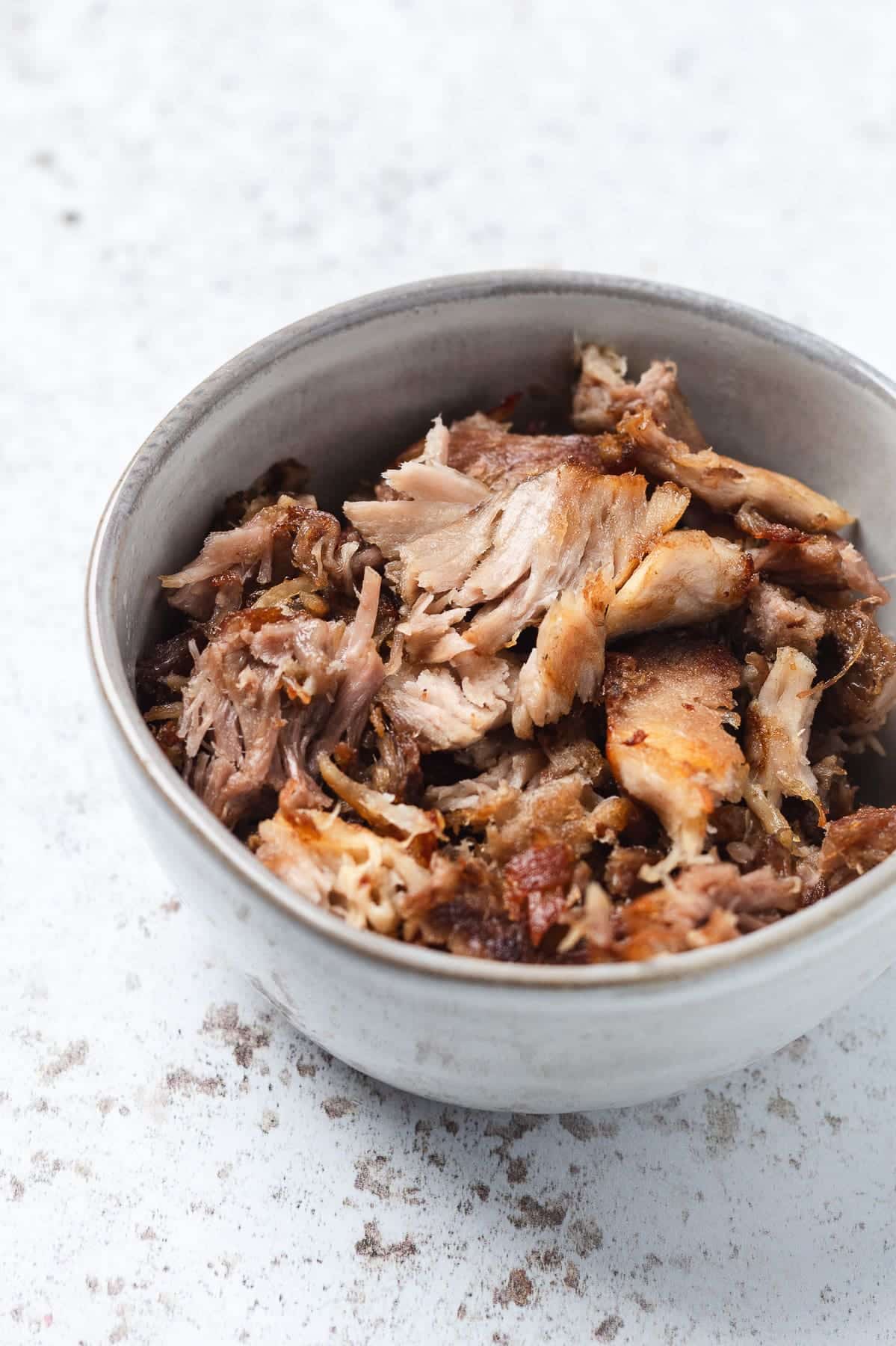 Crispy pulled pork pieces in a bowl.