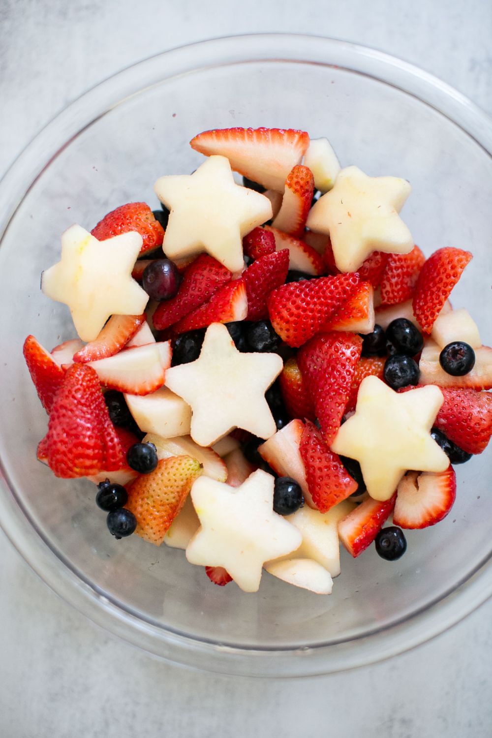 Fresh fruit salad with strawberries, blueberries, and star-shaped apples.