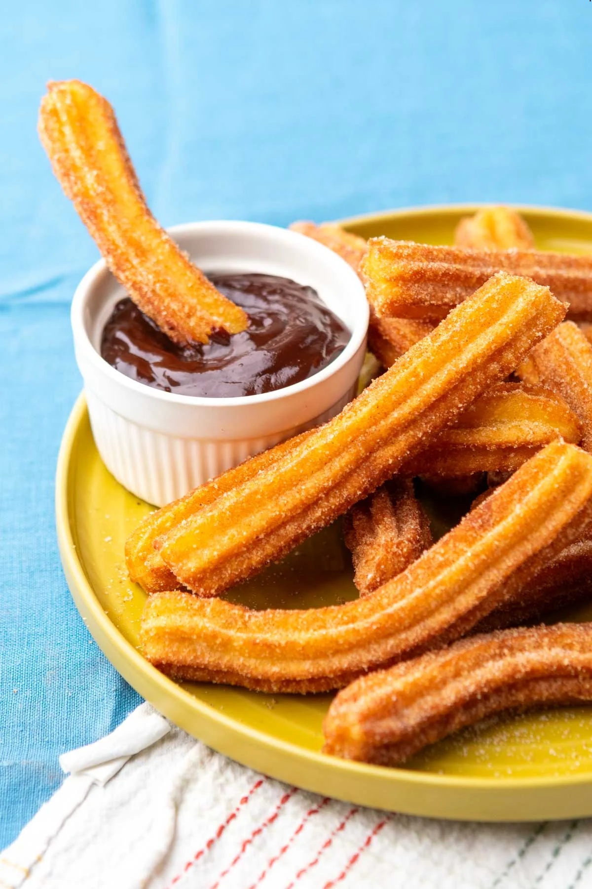 Churros coated in cinnamon sugar with chocolate dipping sauce.
