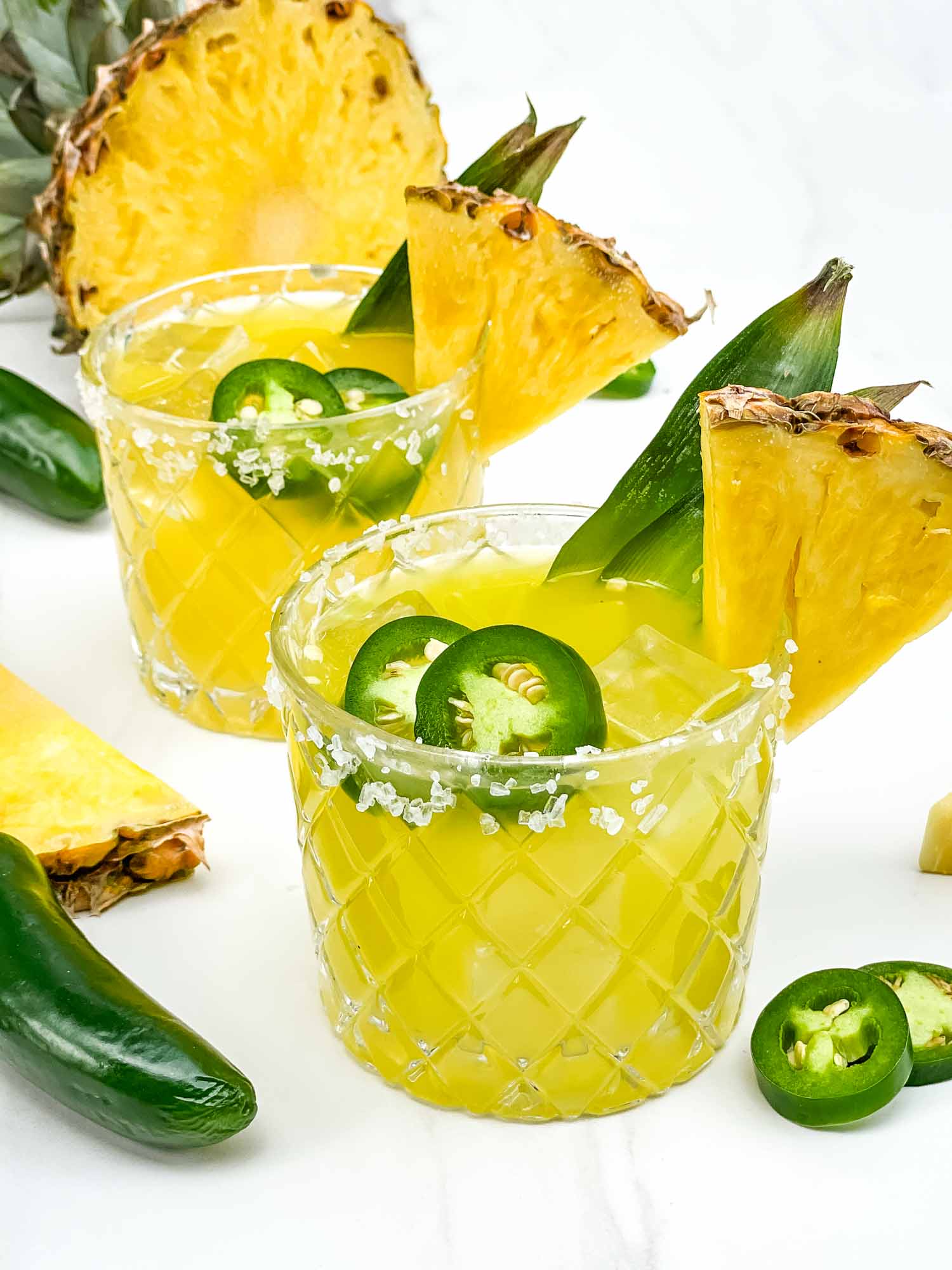 Spicy pineapple mezcal margarita with jalapeño and salted rim.