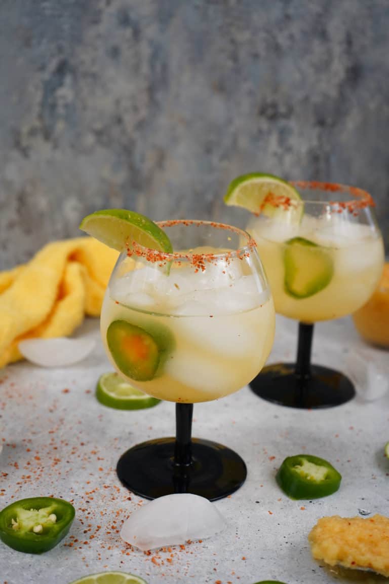 Smoked pineapple margarita with pineapple garnish and chili rim.