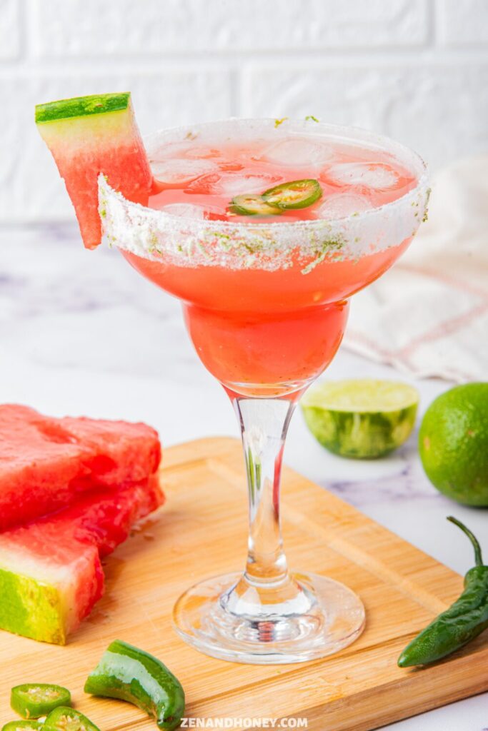 Watermelon jalapeño margarita with salted rim, lime, and fresh watermelon garnish.