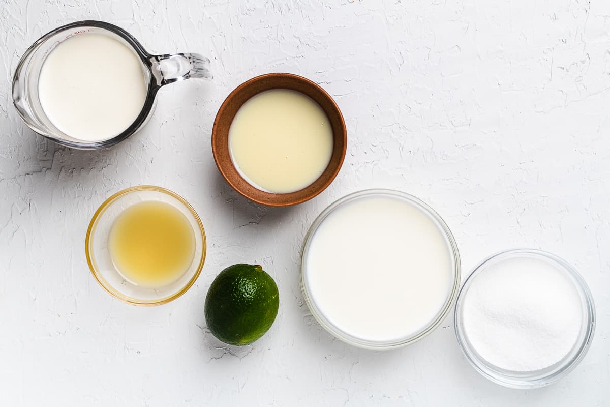 Ingredients for key lime pie popsicles on a table.