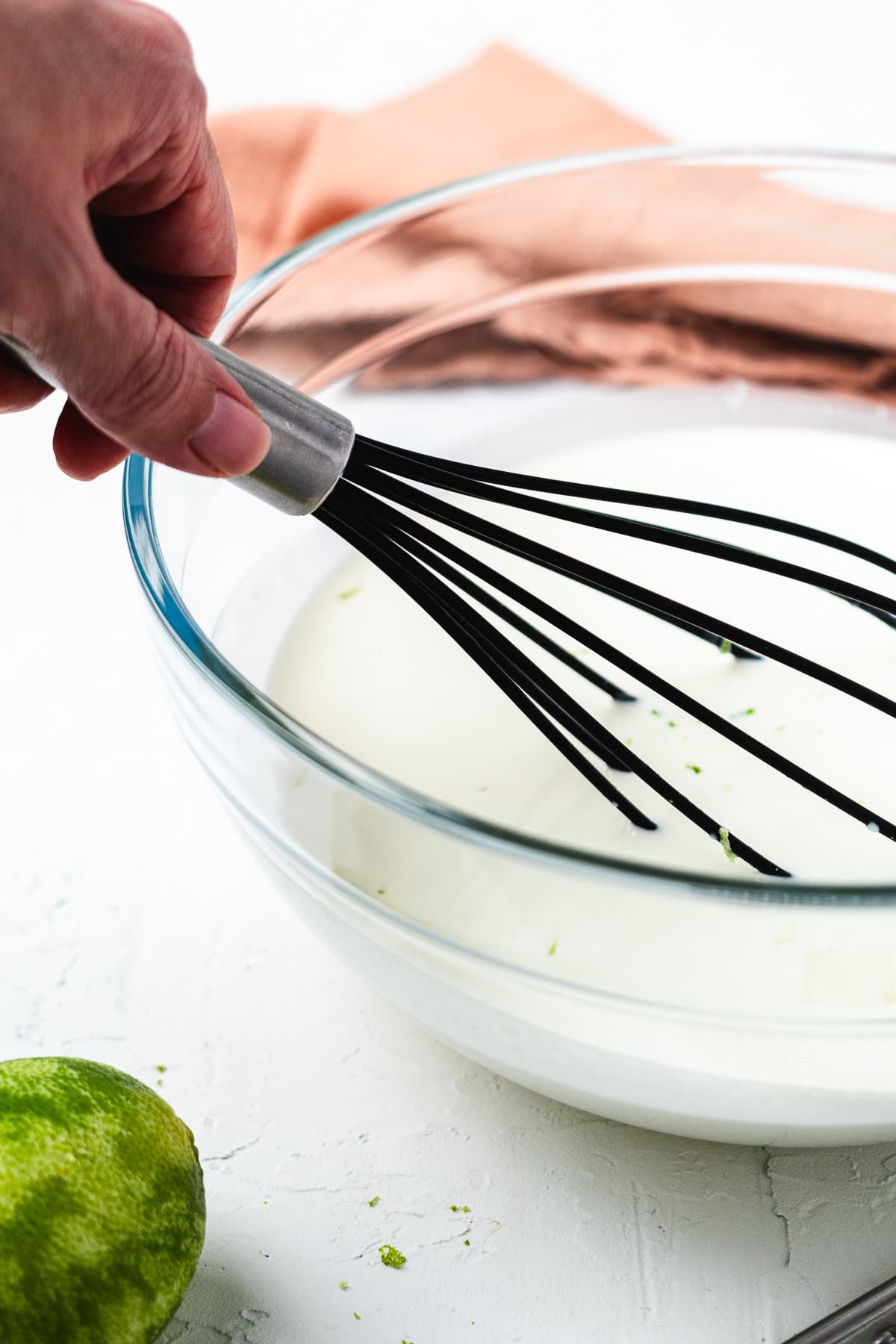 Whisking key lime pie popsicle mixture.