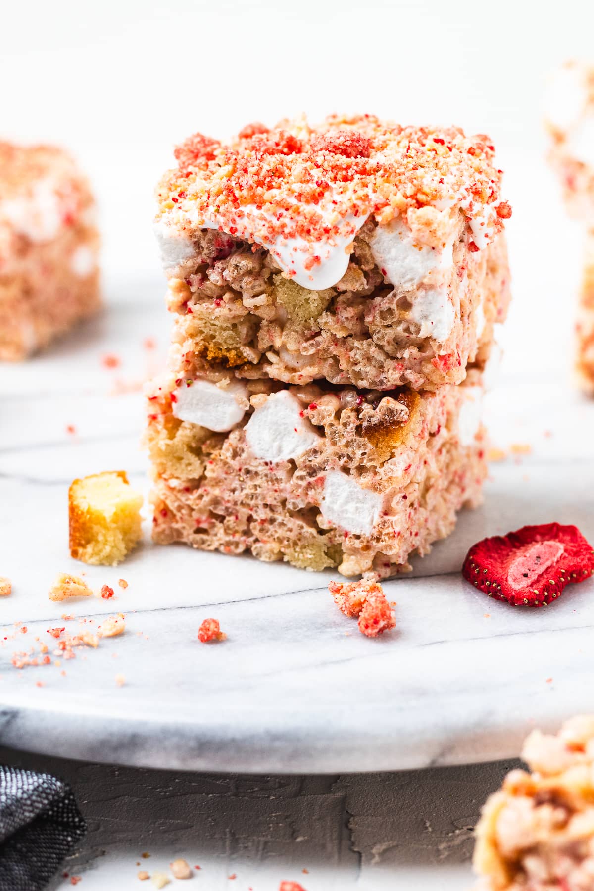 Strawberry shortcake Rice Krispie treats topped with marshmallows and freeze-dried strawberries.