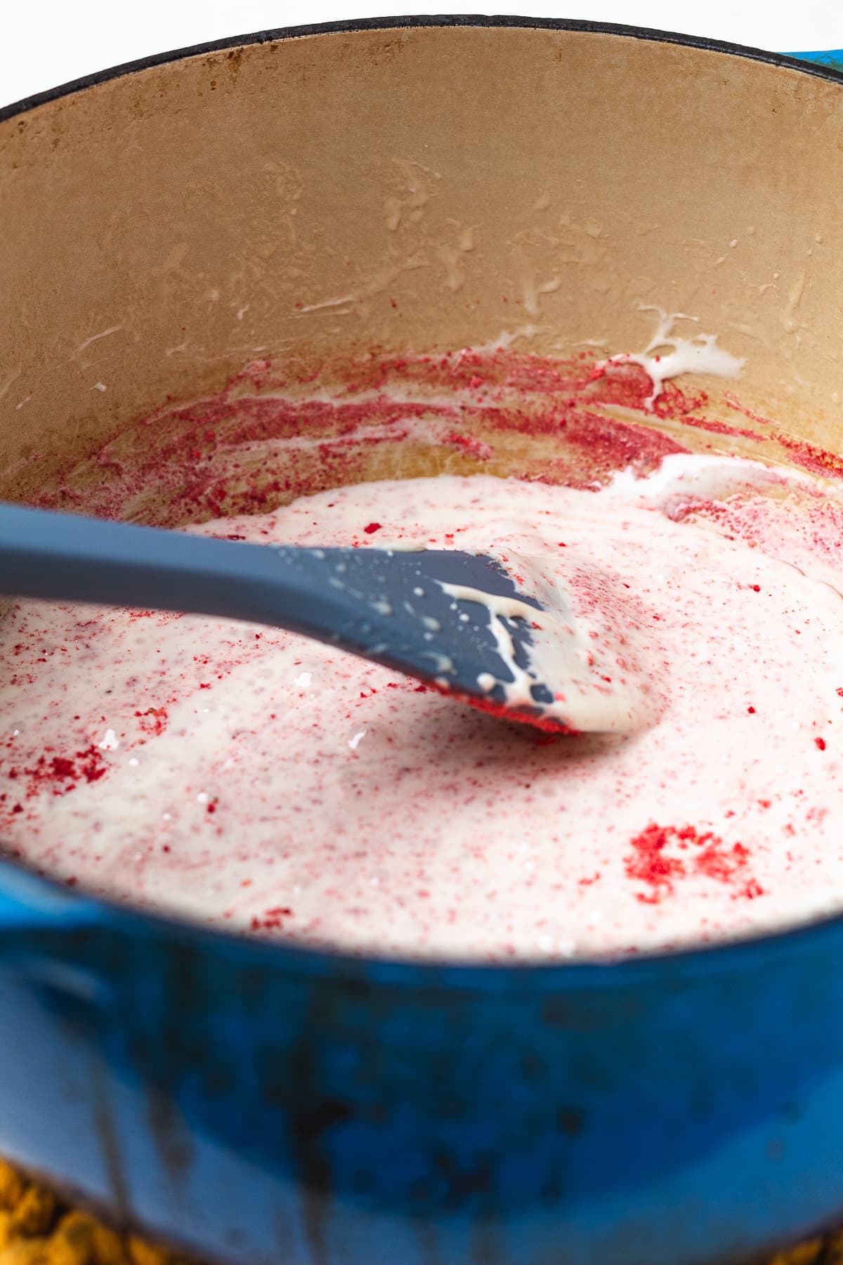 Stirring freeze-dried strawberries into melted marshmallows for strawberry shortcake Rice Krispie treats.
