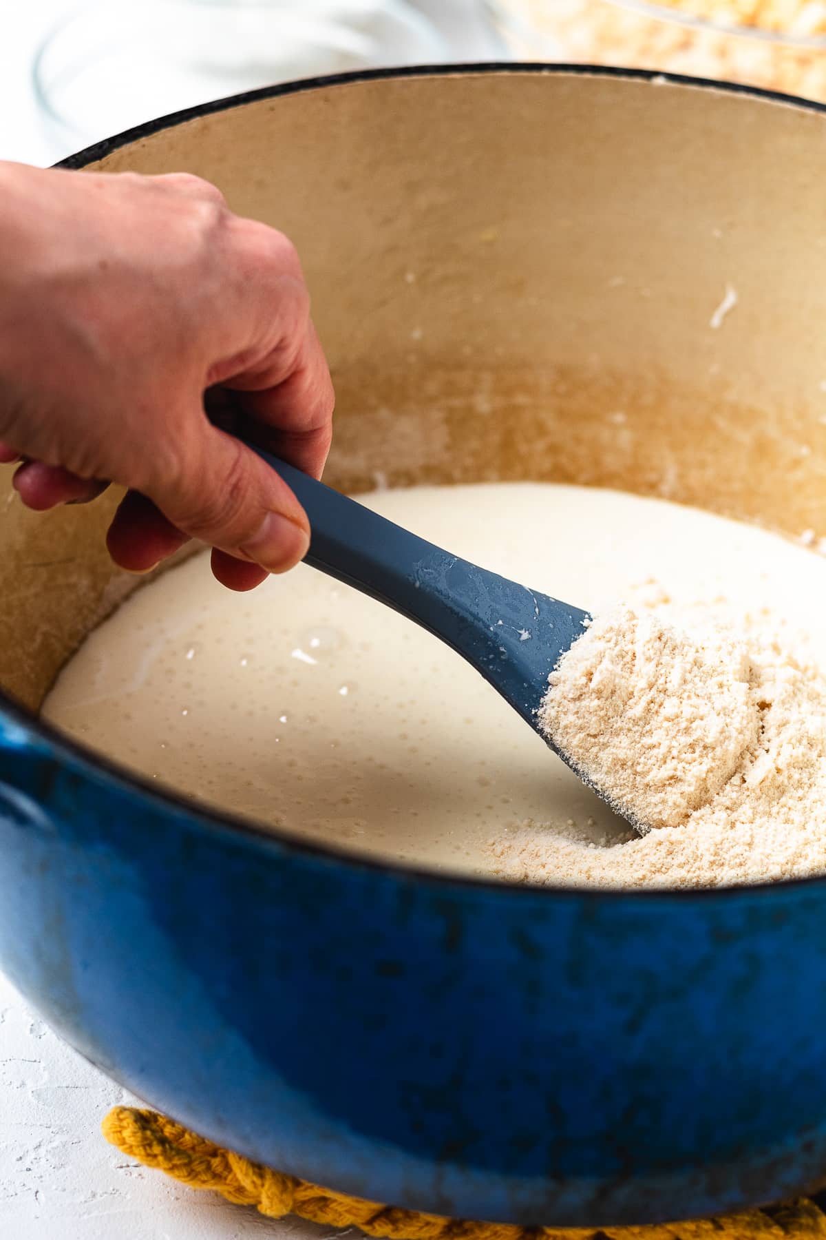 Stirring sugar cookie mix into melted marshmallows.