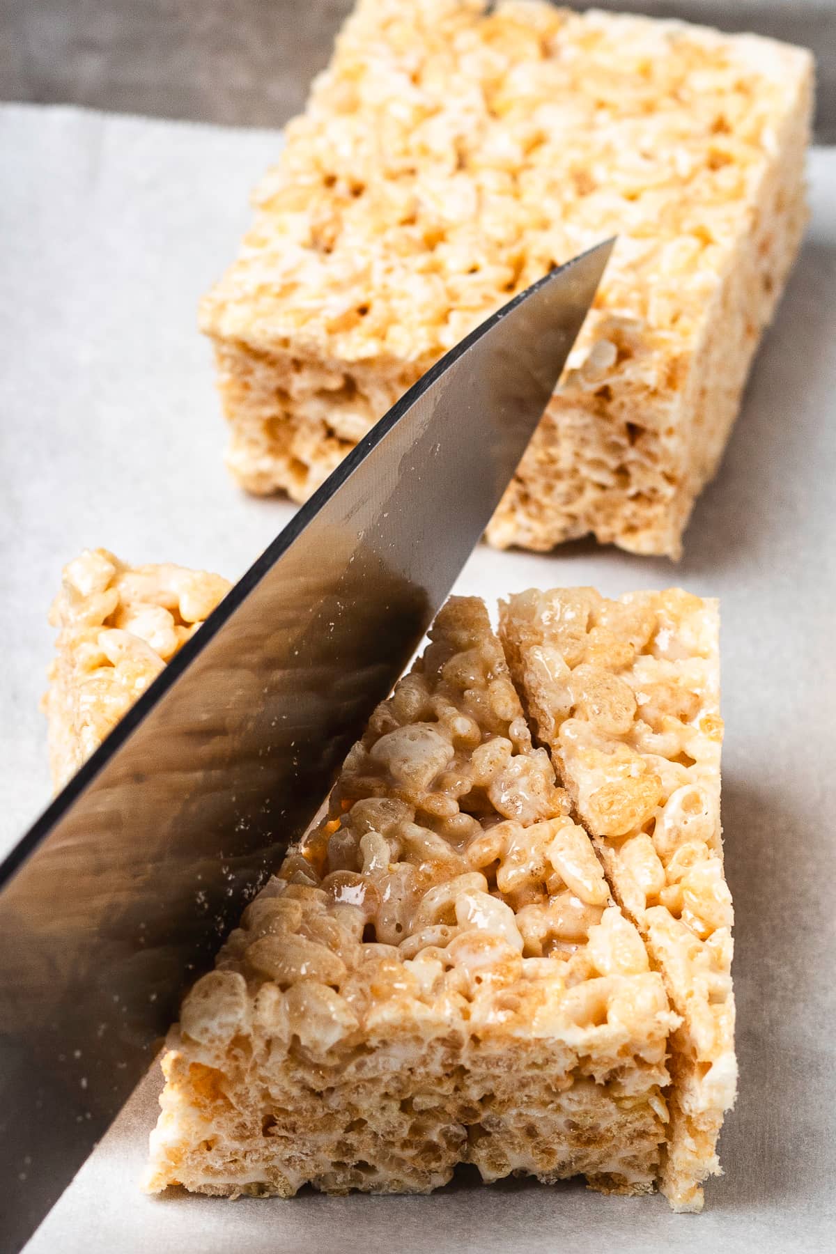 Cutting Rice Krispie treats into triangles.