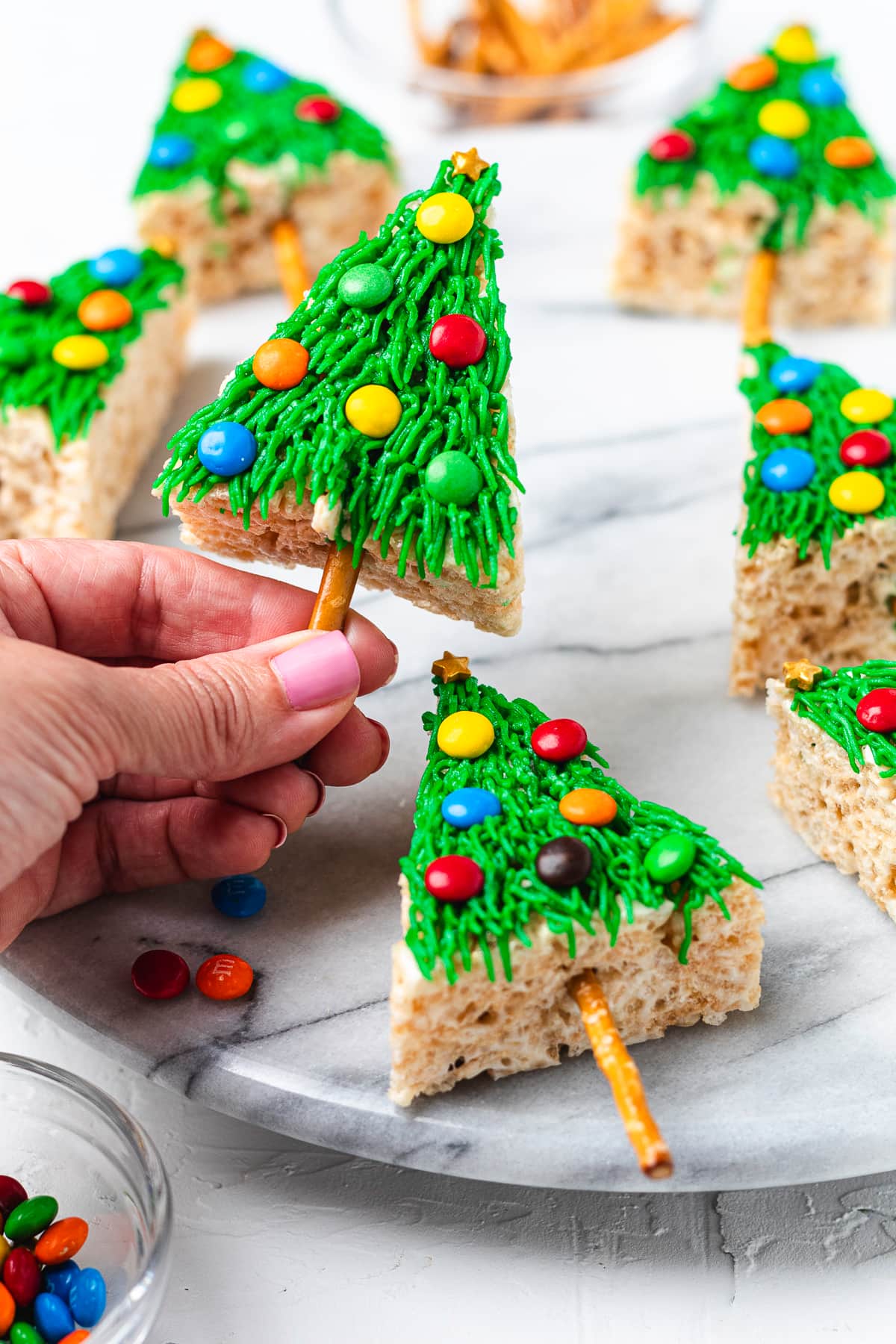Hand holding Christmas tree Rice Krispie treat.