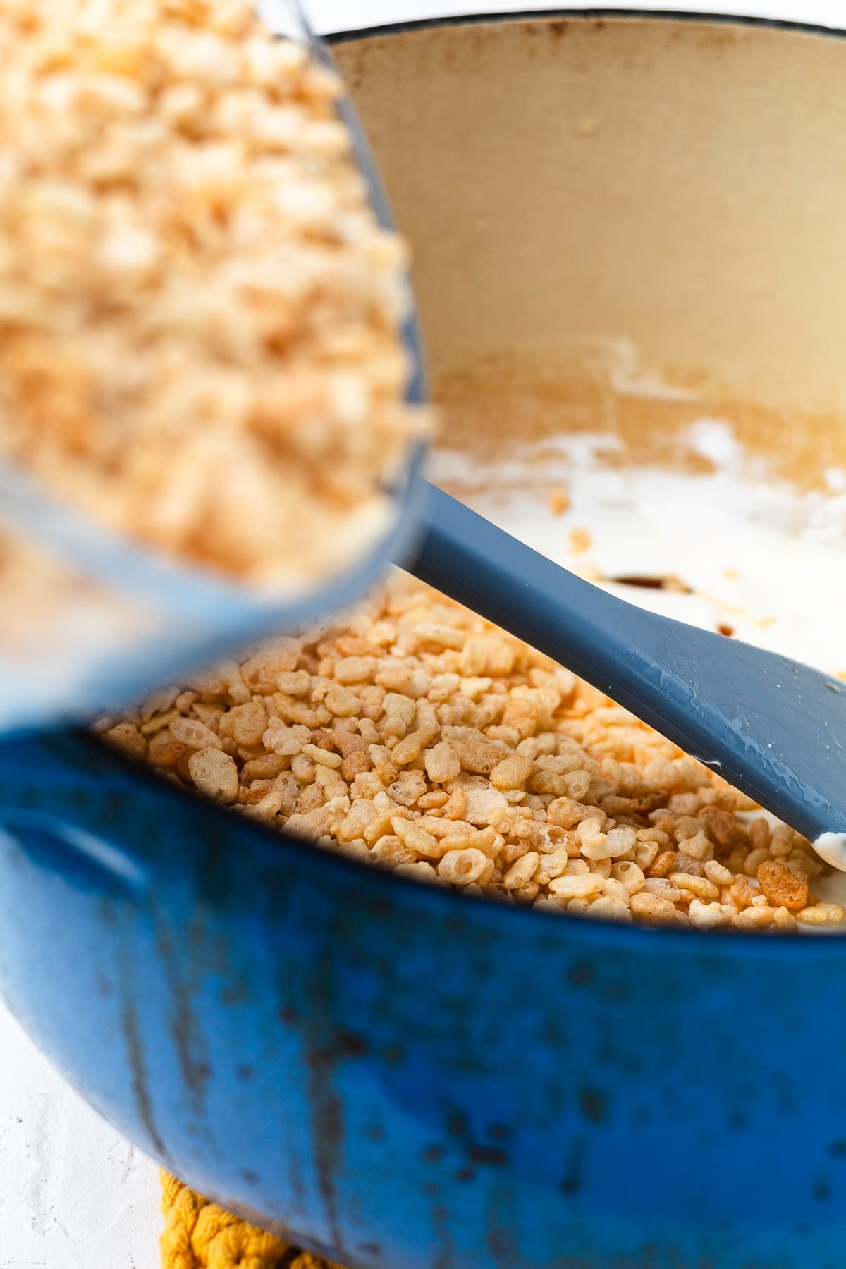 Pot filled with melted marshmallow mixture and rice cereal.