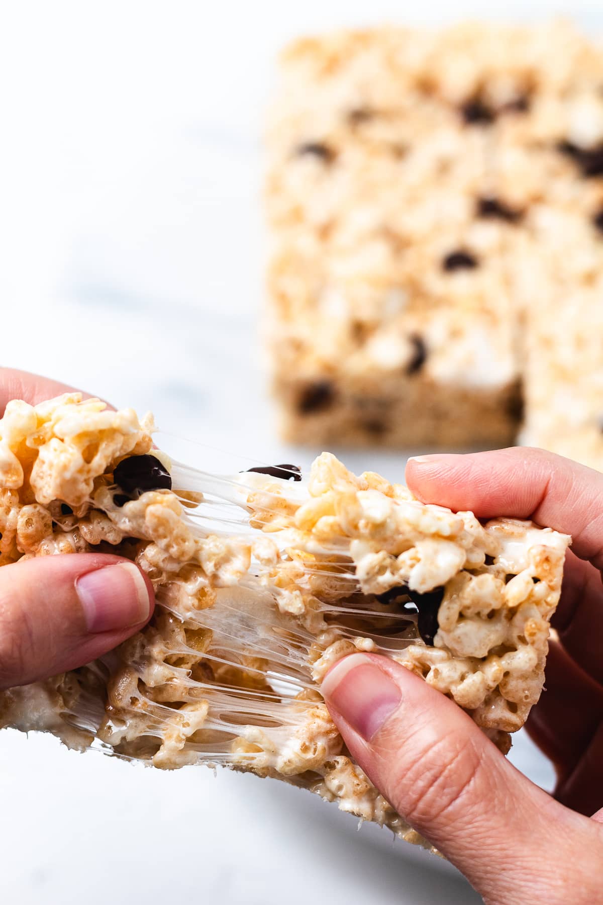 Brown butter Rice Krispie treat pulled apart with melted marshmallow.