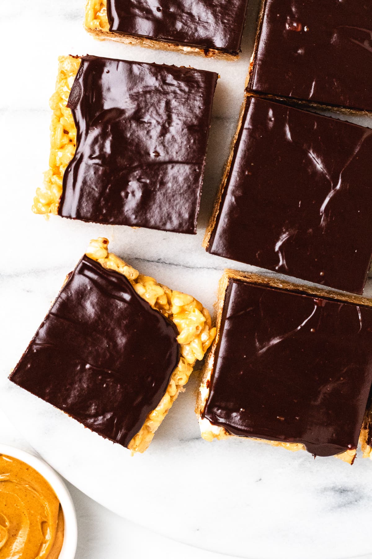 Overhead view of chocolate peanut butter Rice Krispie treats with a smooth chocolate topping.