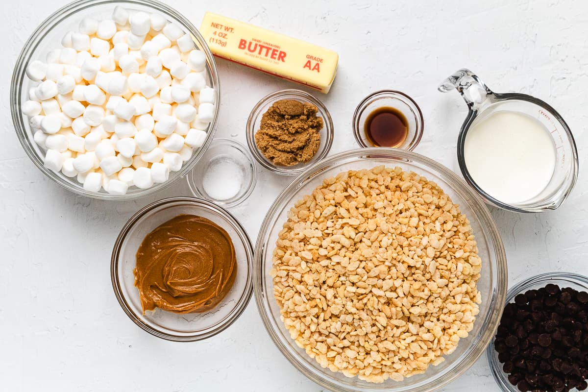 Measured ingredients for chocolate peanut butter Rice Krispie treats arranged on a countertop.