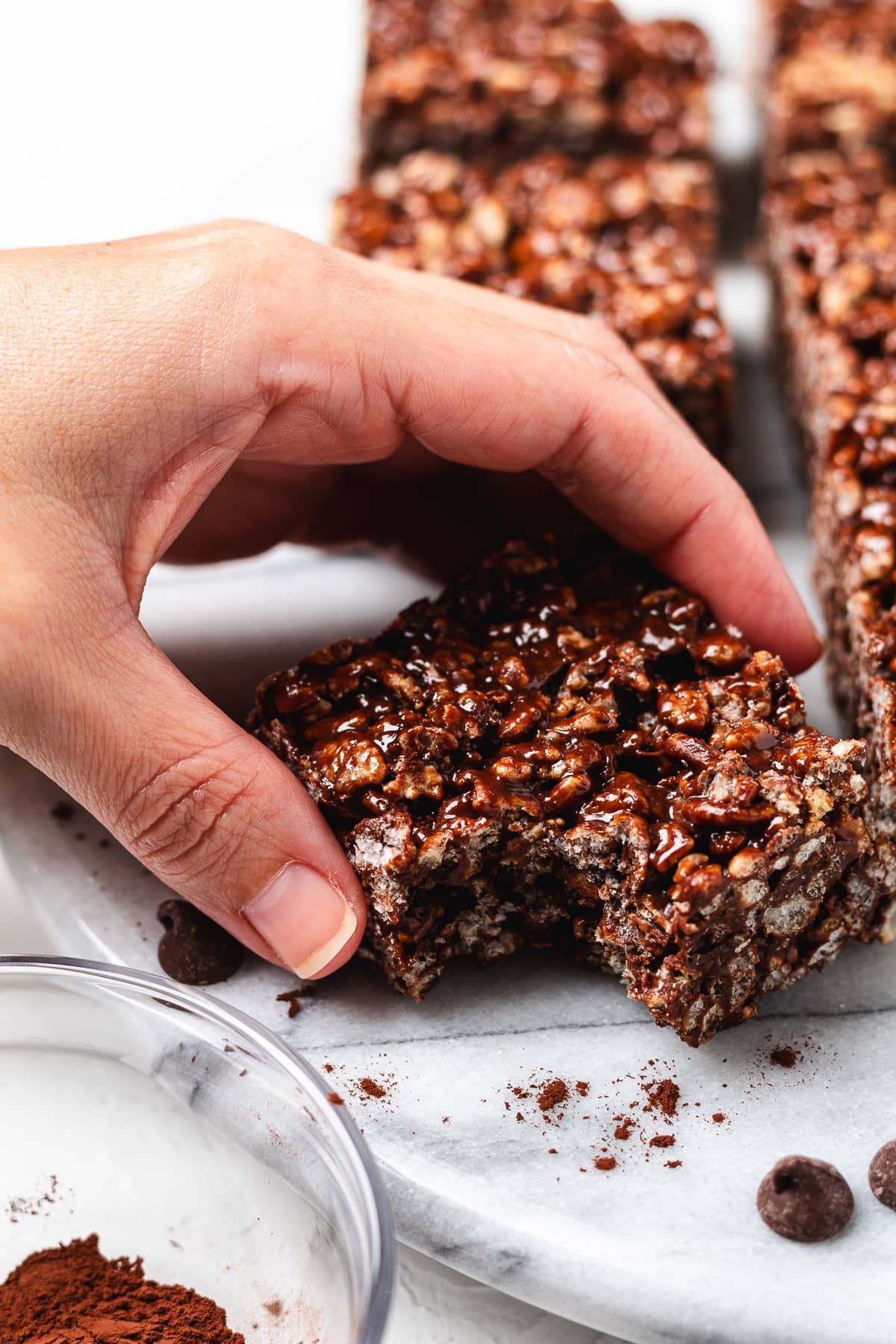 Hand holding a chocolate Rice Krispie treat.