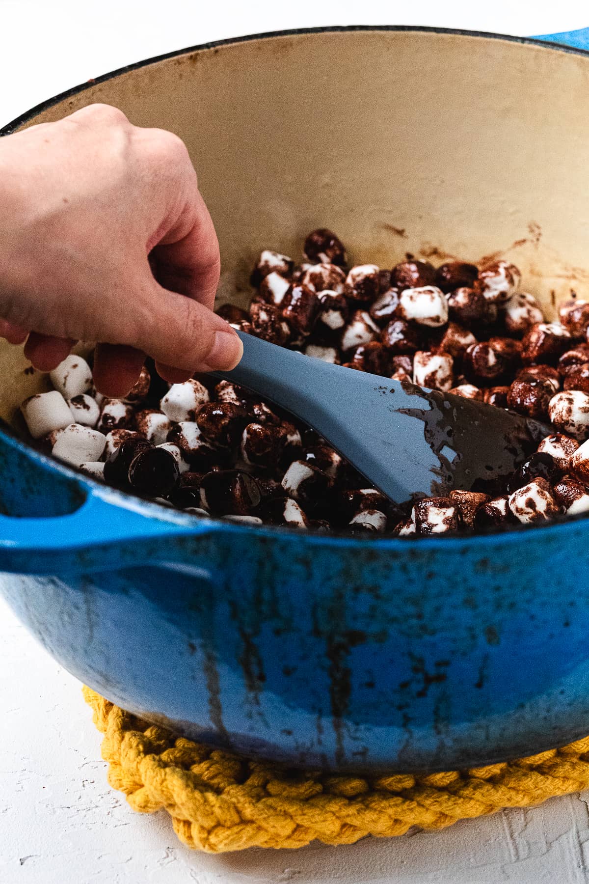 Mixing marshmallows into the chocolate mixture.