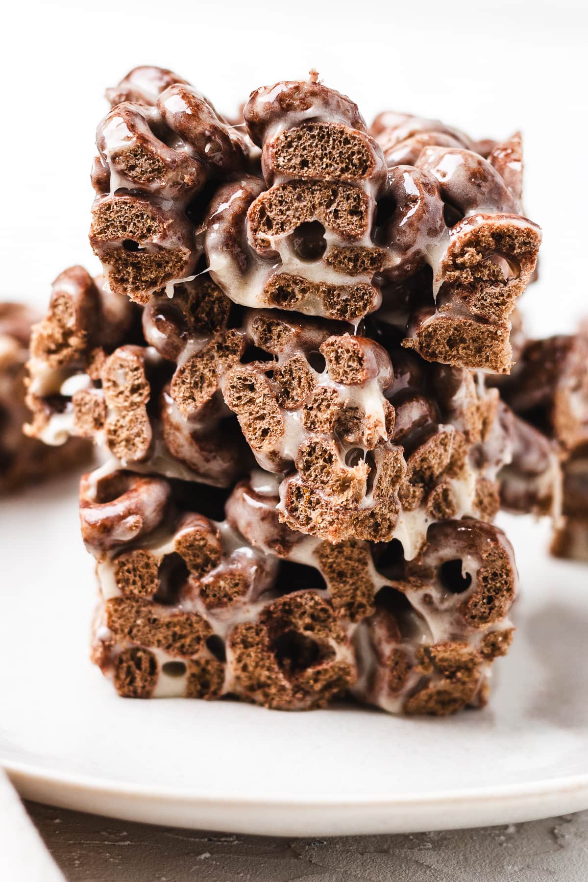 Stack of Cocoa Loops crispy treats on a white plate.