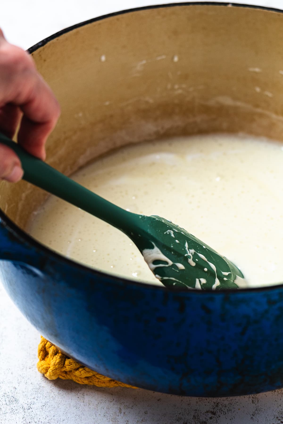 Melted marshmallow mixture in a blue Dutch oven