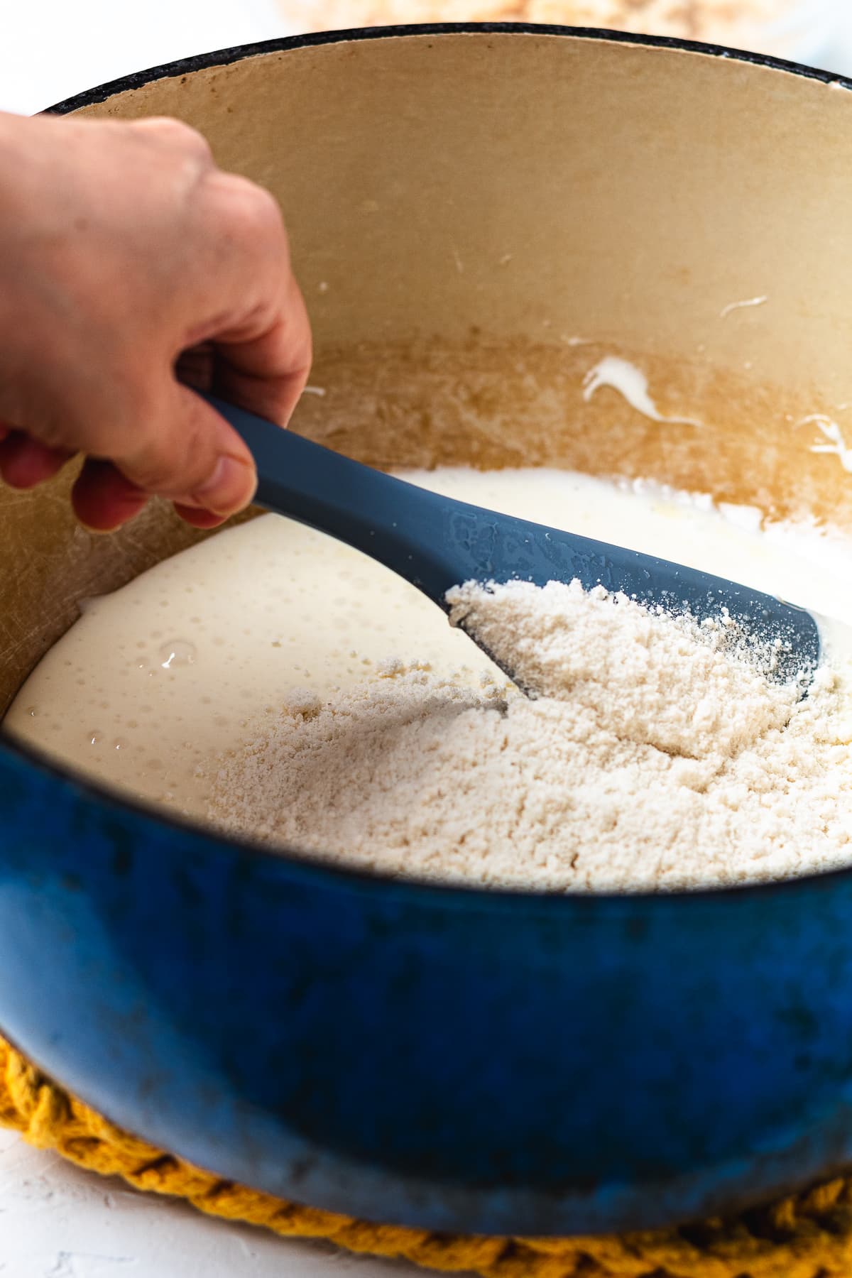 Stirring cake mix into the marshmallow mixture.